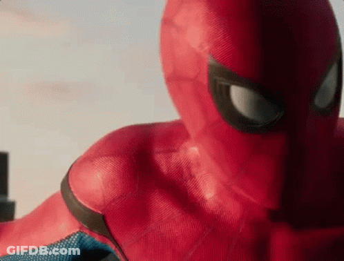 A Close Up Of A Person In A Spiderman Costume Looking At The Camera . GIF