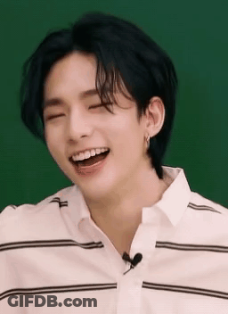 A Close Up Of A Person Laughing With Their Eyes Closed And Their Mouth Open . GIF