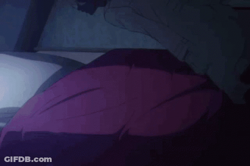 A Close Up Of A Person Laying Down With Their Eyes Closed And Their Mouth Open . GIF