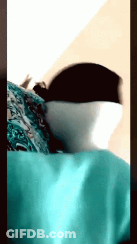 A Close Up Of A Person Laying On A Bed GIF