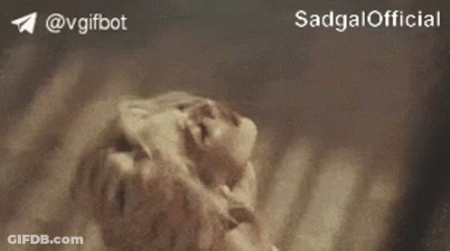 A Close Up Of A Person Laying On The Ground With The Words Sadgal Official On The Bottom . GIF