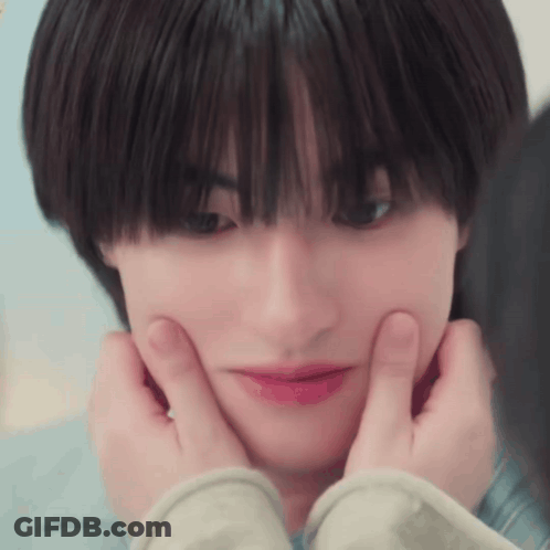 A Close Up Of A Person Making A Face With Their Hands On Their Face . GIF