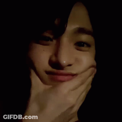 A Close Up Of A Person Making A Funny Face With Their Hand On Their Face . GIF