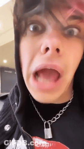 A Close Up Of A Person Making A Funny Face With Their Mouth Open . GIF