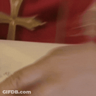 A Close Up Of A Person Opening A Gift Box GIF