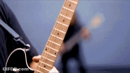 A Close Up Of A Person Playing A Guitar With A Blue Background . GIF