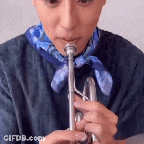 A Close Up Of A Person Playing A Trumpet . GIF