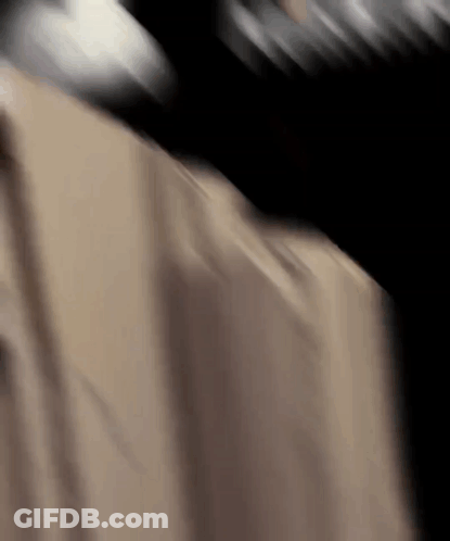 A Close Up Of A Person 'S Back With A Black Background GIF