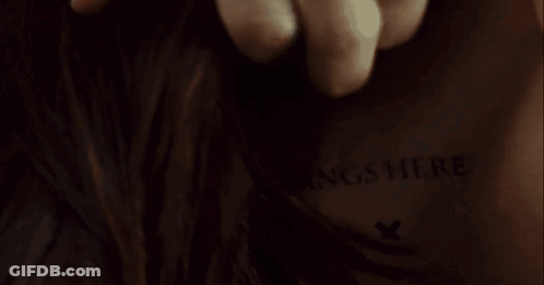 A Close Up Of A Person 'S Back With The Words Insert Fangs Here Written On It GIF
