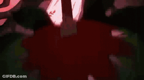 A Close Up Of A Person 'S Chest In A Dark Room With A Red Light Coming Out Of It . GIF