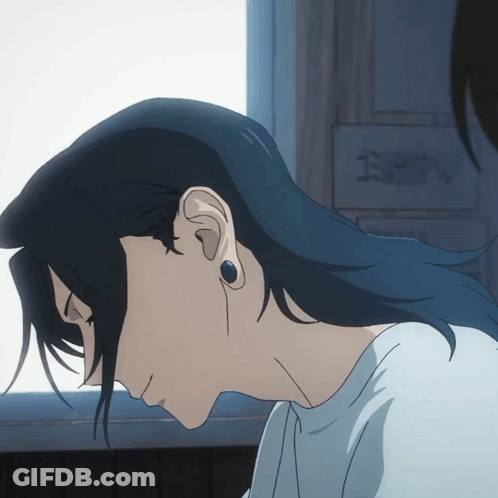 A Close Up Of A Person 'S Ear With A Sign In The Background That Says " E " GIF