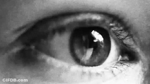 A Close Up Of A Person 'S Eye In A Black And White Photo GIF