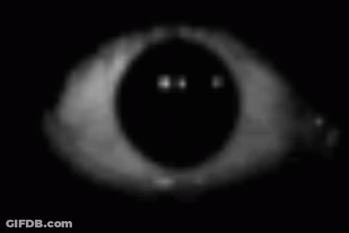 A Close Up Of A Person 'S Eye In The Dark With A Smiley Face On It . GIF