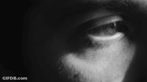 A Close Up Of A Person 'S Eye With A Dark Background GIF
