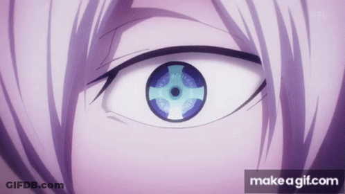 A Close Up Of A Person 'S Eye With A Purple Iris And A Blue Eye . GIF