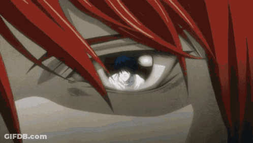 A Close Up Of A Person 'S Eye With Red Hair And A Blue Eye GIF