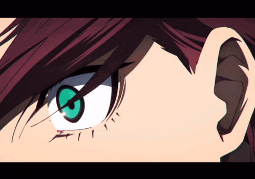 A Close Up Of A Person 'S Eye With Red Hair And Green Eyes GIF