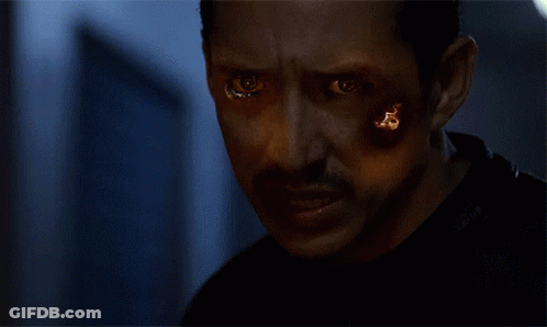A Close Up Of A Person 'S Face Covered In Fire GIF