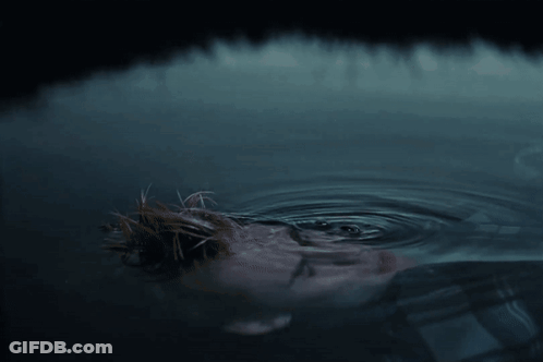 A Close Up Of A Person 'S Face In A Body Of Water GIF