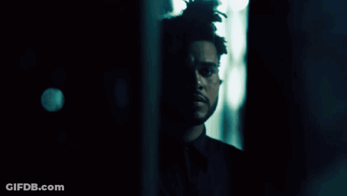 A Close Up Of A Person 'S Face In A Dark Room . GIF
