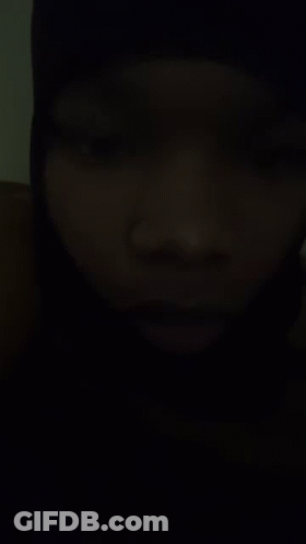 A Close Up Of A Person 'S Face In A Dark Room . GIF