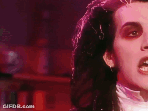 A Close Up Of A Person 'S Face In A Dark Room GIF