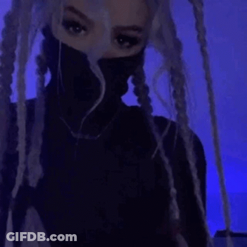 A Close Up Of A Person 'S Face In A Dark Room With A Blue Light In The Background . GIF