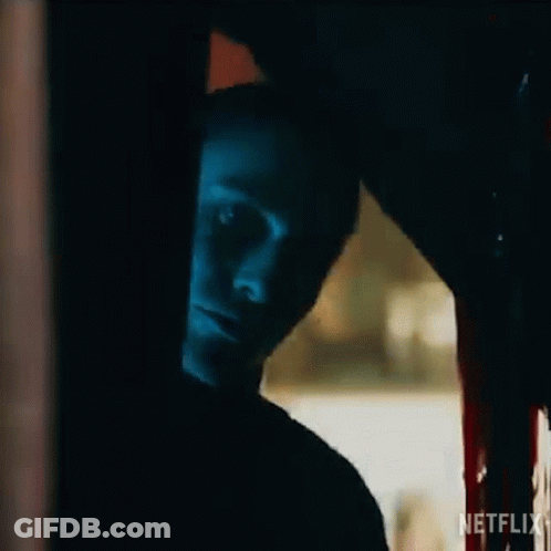 A Close Up Of A Person 'S Face In A Dark Room With Blood On The Floor . GIF