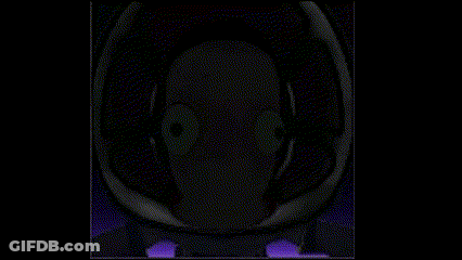 A Close Up Of A Person 'S Face In A Dark Room With Purple Lights . GIF