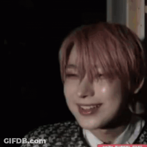 A Close Up Of A Person 'S Face In A Dark Room . GIF