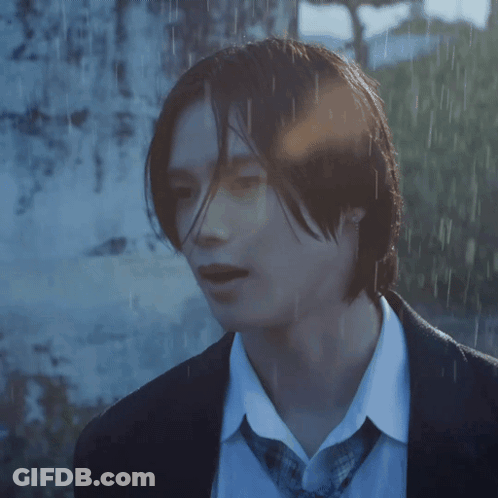 A Close Up Of A Person 'S Face In A Suit And Tie GIF