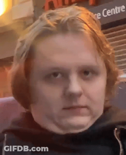 A Close Up Of A Person 'S Face In Front Of A Sign That Says ' Centre ' GIF