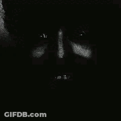 A Close Up Of A Person 'S Face In The Dark With Their Eyes Closed . GIF