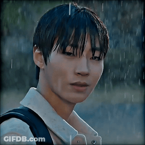 A Close Up Of A Person 'S Face In The Rain With A Backpack GIF