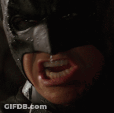 A Close Up Of A Person 'S Face Wearing A Batman Mask GIF