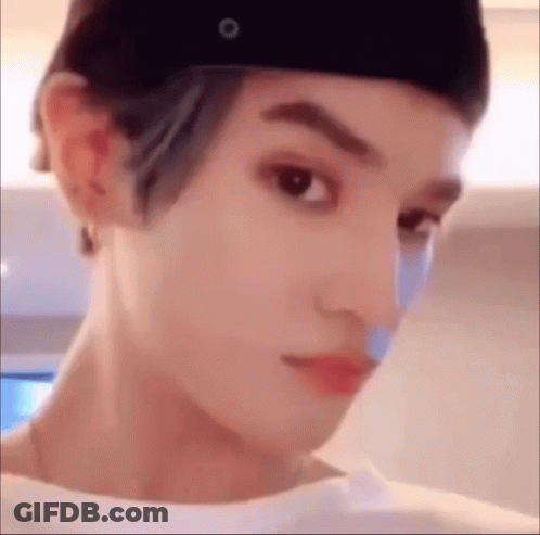 A Close Up Of A Person 'S Face Wearing A Hat And A Bandage On Their Nose . GIF