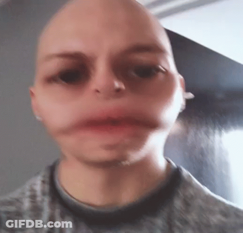 A Close Up Of A Person 'S Face With A Bald Head . GIF