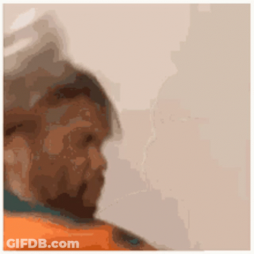 A Close Up Of A Person 'S Face With A Beard And A Blurred Background . GIF