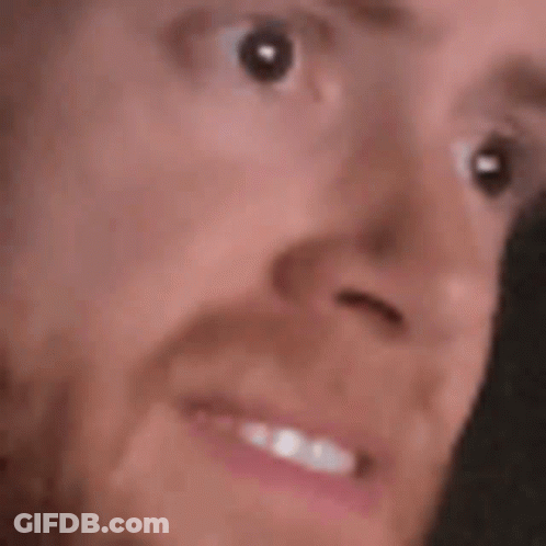 A Close Up Of A Person 'S Face With A Beard And A Smile . GIF