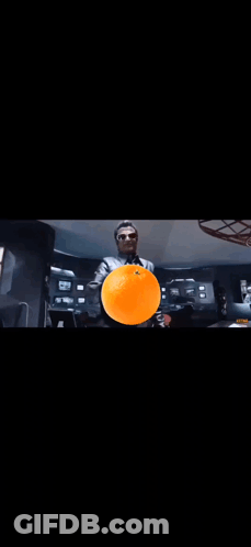 A Close Up Of A Person 'S Face With A Black Background And Orange Smoke Coming Out Of It . GIF