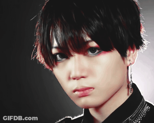 A Close Up Of A Person 'S Face With A Black Background And The Letters Aa And Ea On The Bottom GIF