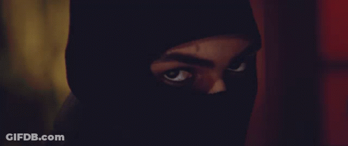A Close Up Of A Person 'S Face With A Black Mask On GIF
