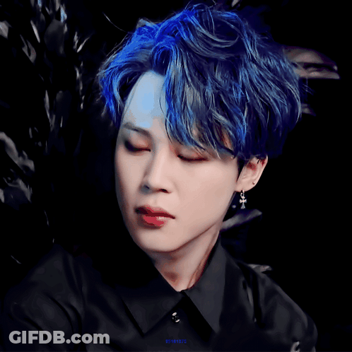 A Close Up Of A Person 'S Face With A Black Shirt And Blue Hair GIF