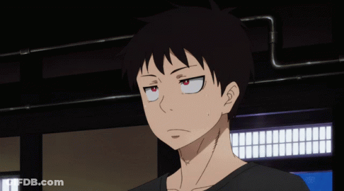 A Close Up Of A Person 'S Face With A Black Shirt And Red Eyes GIF