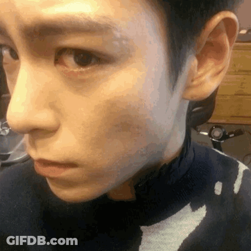 A Close Up Of A Person 'S Face With A Black Sweater On GIF