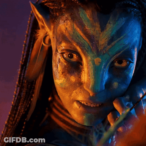 A Close Up Of A Person 'S Face With A Blue And Green Face Paint GIF