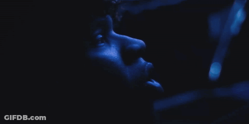 A Close Up Of A Person 'S Face With A Blue Background GIF
