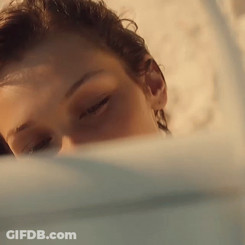 A Close Up Of A Person 'S Face With A Blue Background GIF