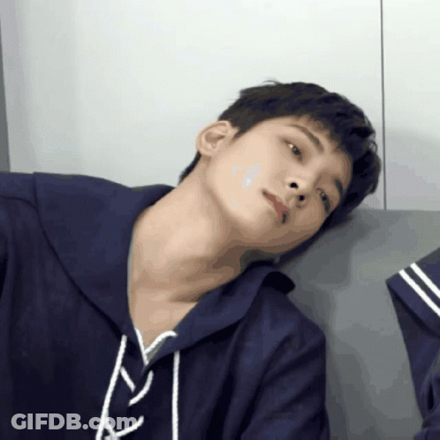 A Close Up Of A Person 'S Face With A Blue Hoodie On GIF