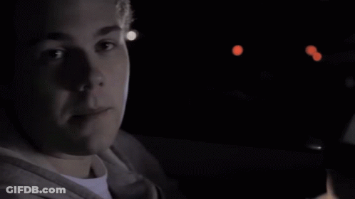 A Close Up Of A Person 'S Face With A Blue Light Behind Them GIF